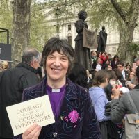 Bishop Rachel with the statue of Millicent Fawcett and a plaque saying Courage calls to courage everywhere