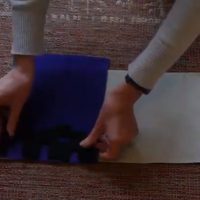 Hands laying a purple cloth