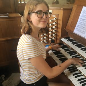 Rachel sitting at the organ