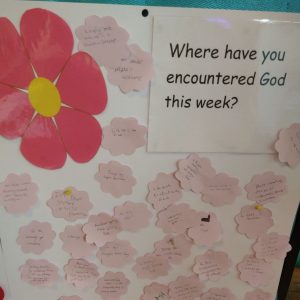 A poster wuth the words Where have you encountered God this week? and postit notes with answers like on my drive, in the kindness of others, in my tears.... and many more.